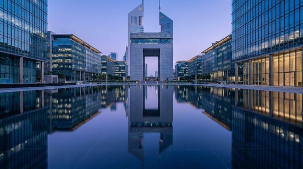 The Dubai financial district reflected on water at blue hour, representing a Canadian founder setting up a Dubai company