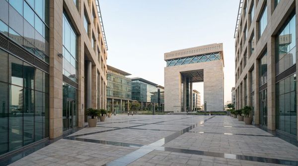 The Dubai International Financial Centre plaza in morning light, representing a Dutch founder setting up a Dubai company