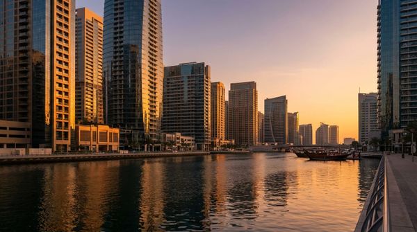 The Dubai waterfront business district at sunset, representing a Portuguese founder setting up a Dubai company