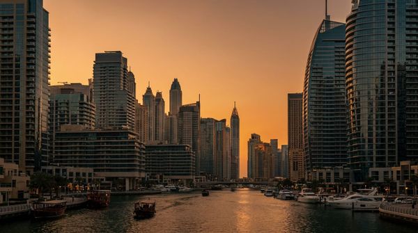 A UAE financial-district skyline at golden hour, representing a UAE holding company structure