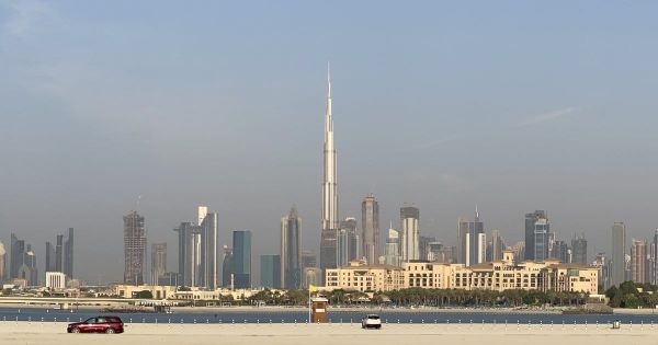 Dubai skyline with the Burj Khalifa seen across the water from Jumeirah beach.