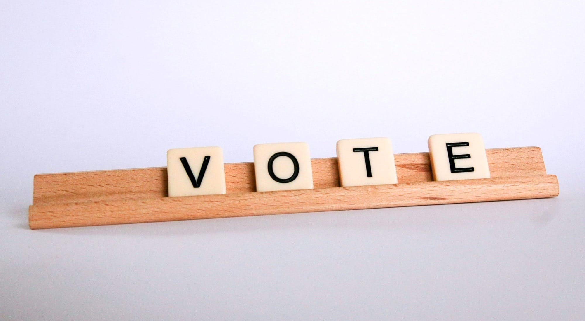 Scrabble tiles spell out the word "VOTE."