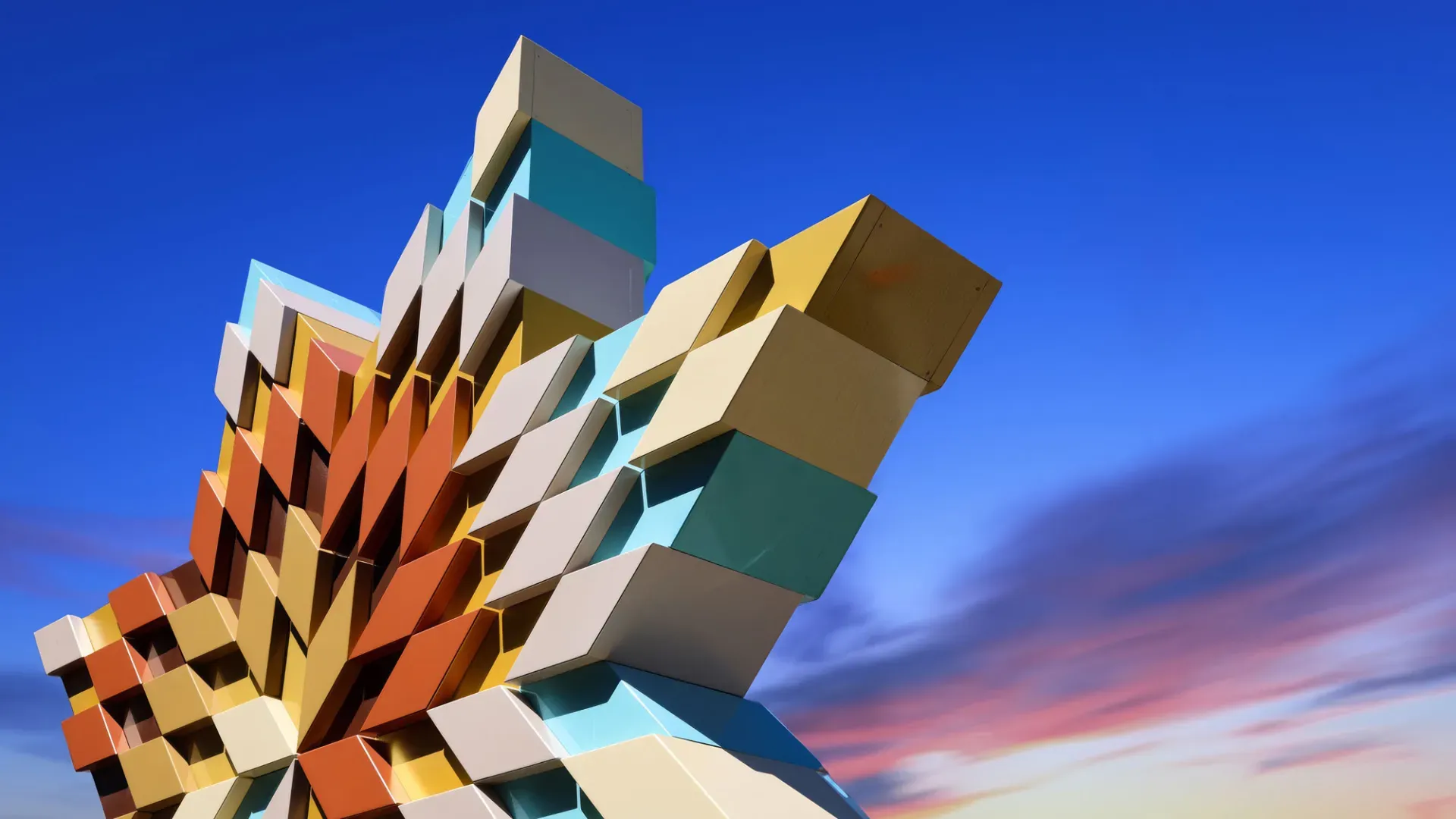Viewed from below, a large multicoloured star-shaped sculpture punctuates a blue and purple sky.