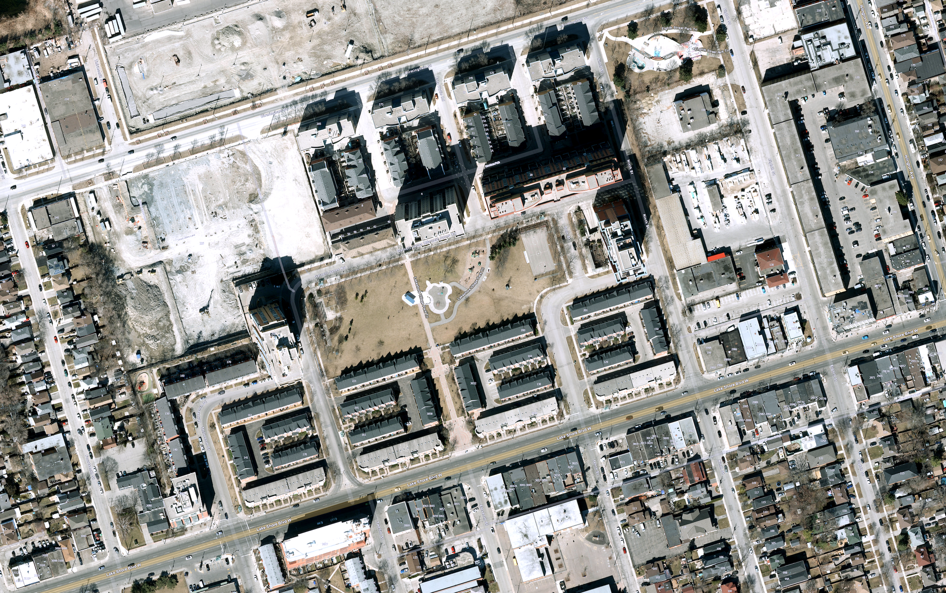 Aerial view of a residential Toronto neighbourhood, showing a large group of housing co-operatives arranged around a park.