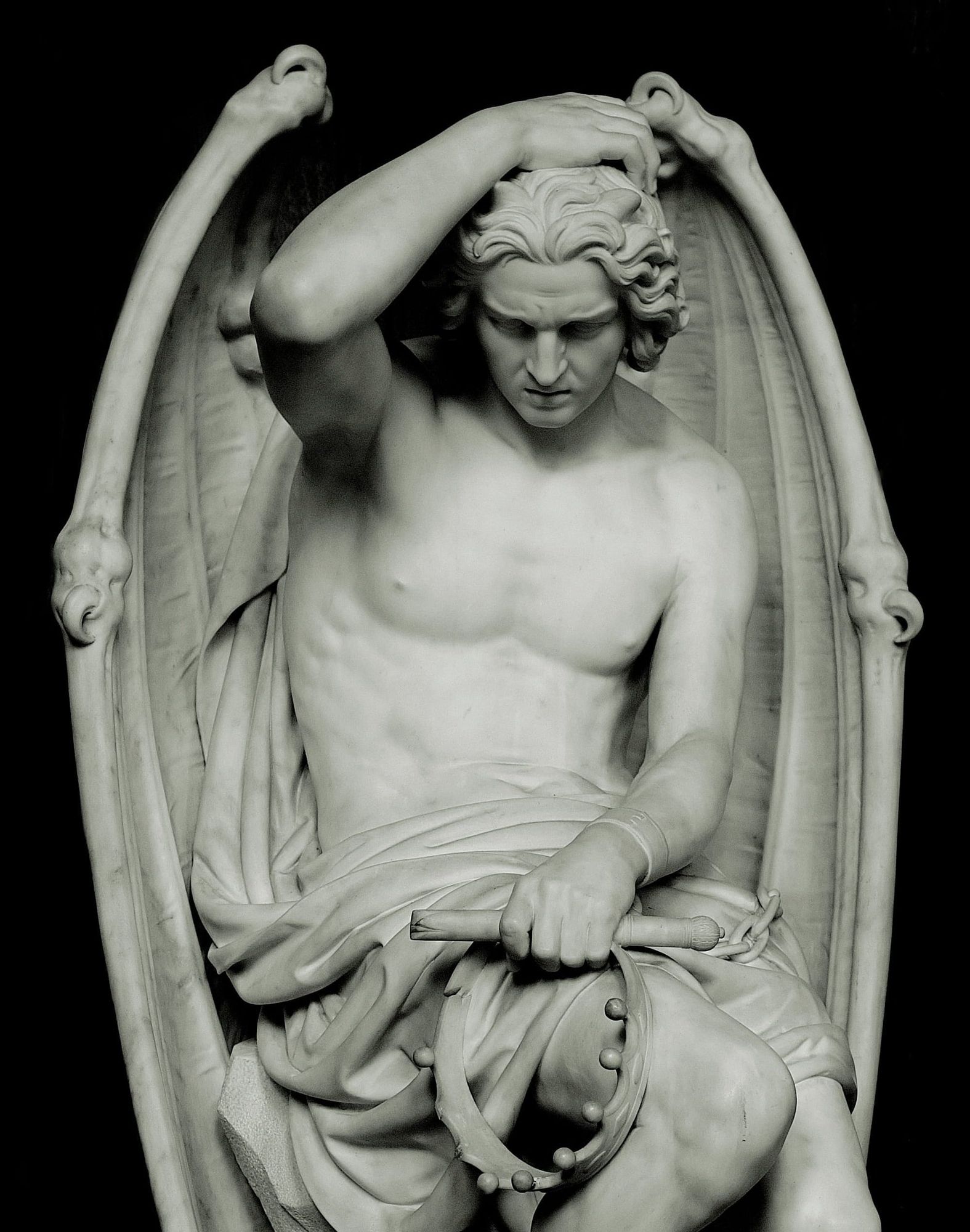 The marble statue clutches a broken crown, bows its head in despair, and a single tear runs down its cheek. Off screen is its shackled ankle. 