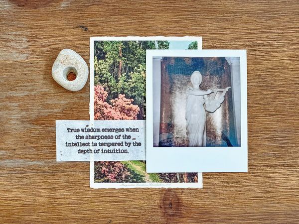 Kodak photos. A slip of paper with the words "true wisdom emerges when the sharpness of the intellect is tempered by the depth of intuition"