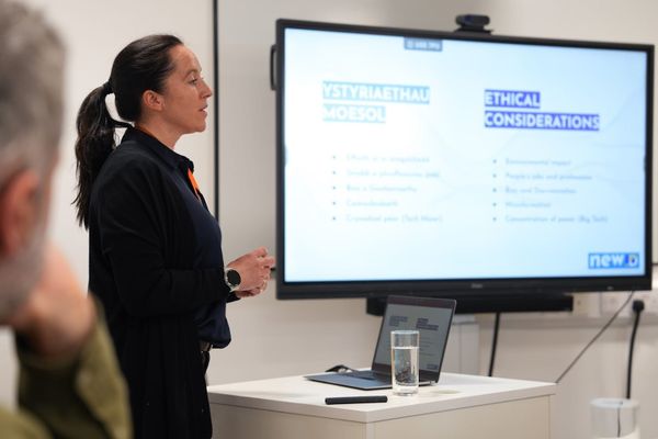 A trainer speaking in front of a slide that says 'Ethical Considerations' of AI