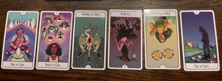 6-card pull featuring 9 of Cups, 7 of Cups, 3 of Swords (R), The Devil (R), 2 of Pentacles (R), and 5 of Cups
