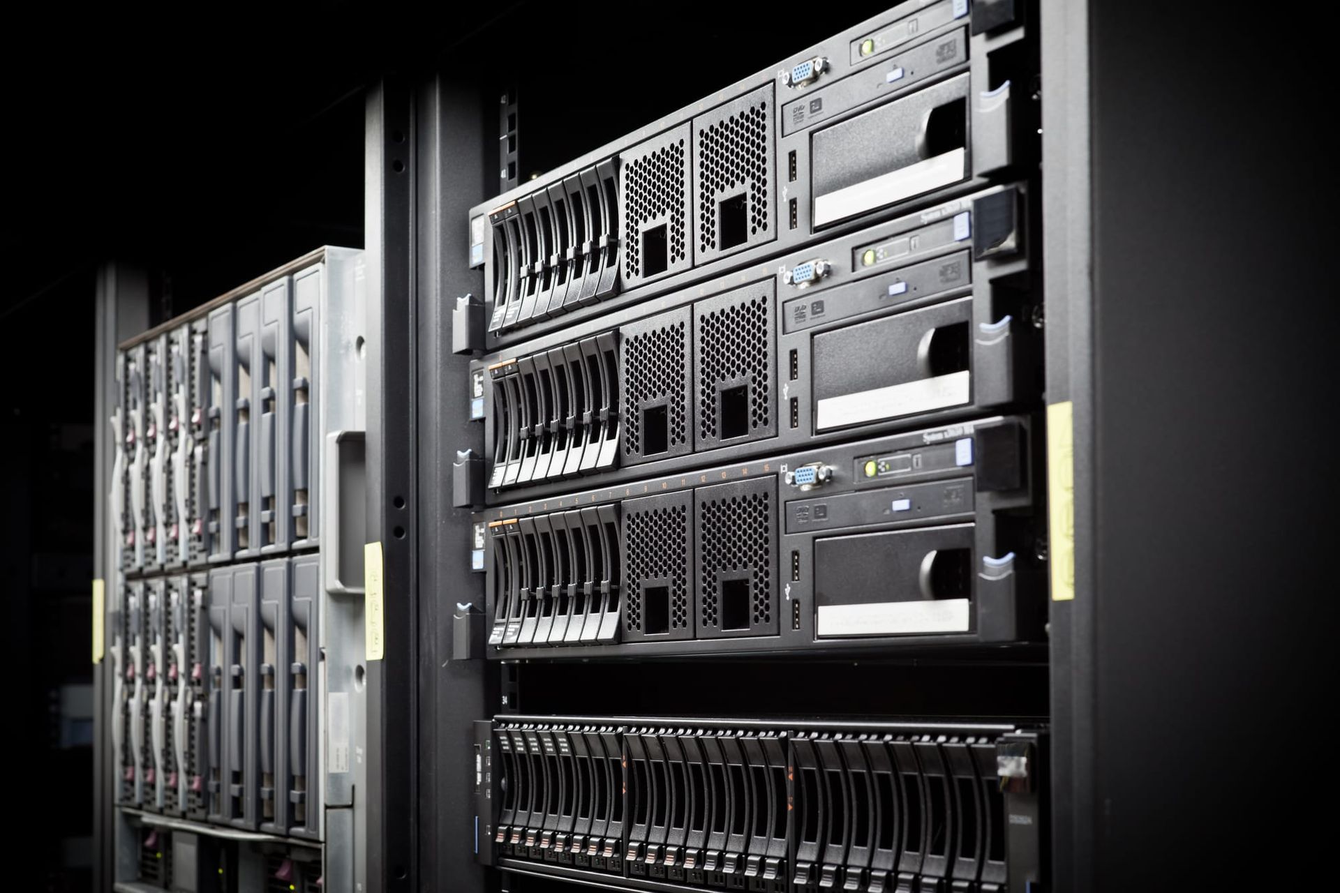 Rows of rack-mounted servers and storage equipment inside a dimly lit data center - Cohere funding