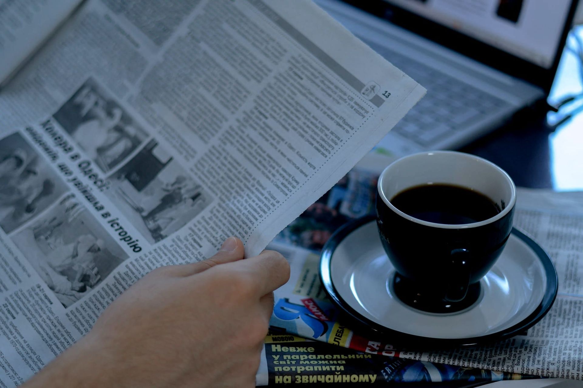 Laptop, coffee cup and newspaper on a desk - Meta commercial terms