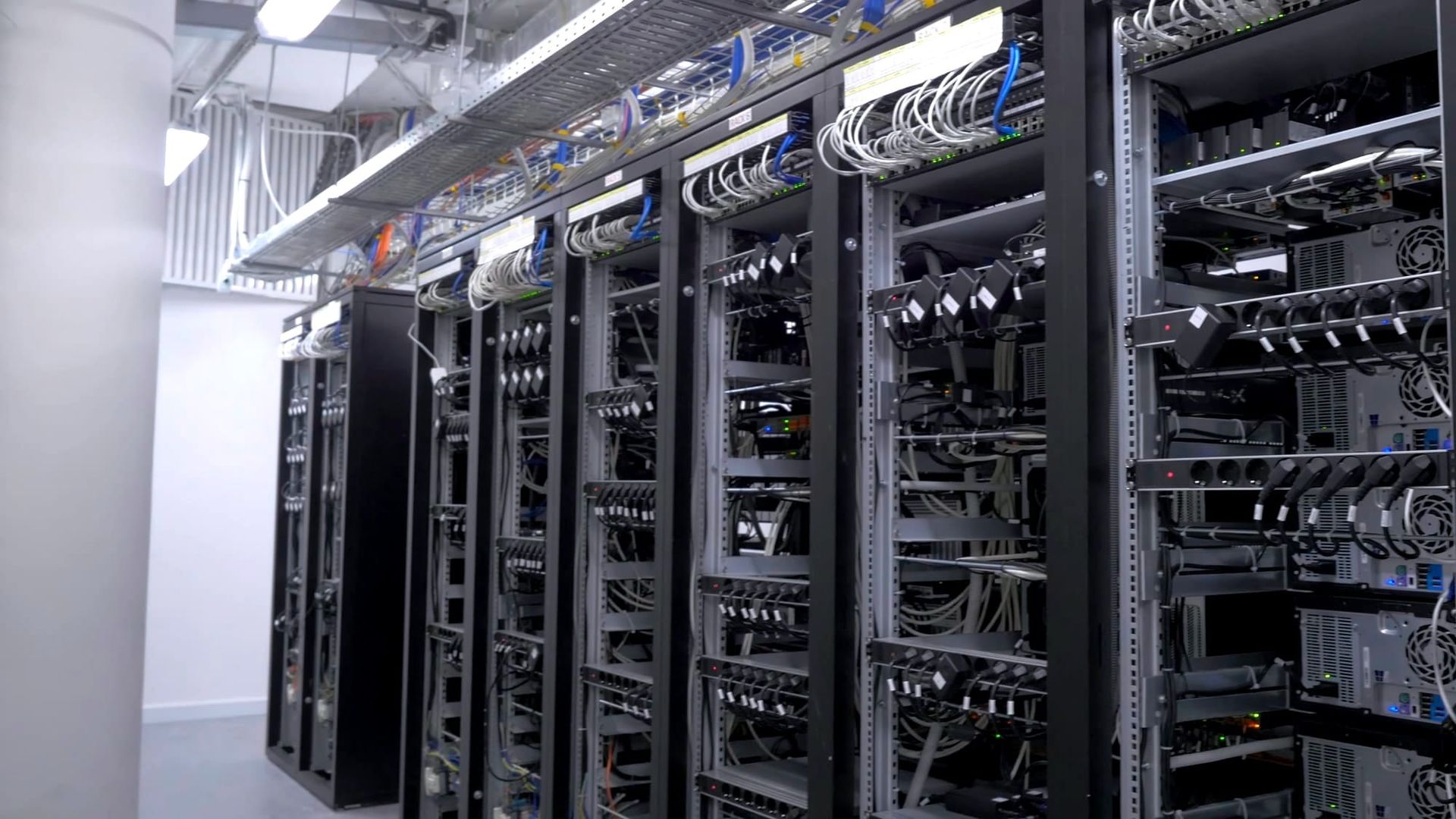 A corridor lined with tall server racks and networking equipment in a data center - Microsoft and Alphabet earnings