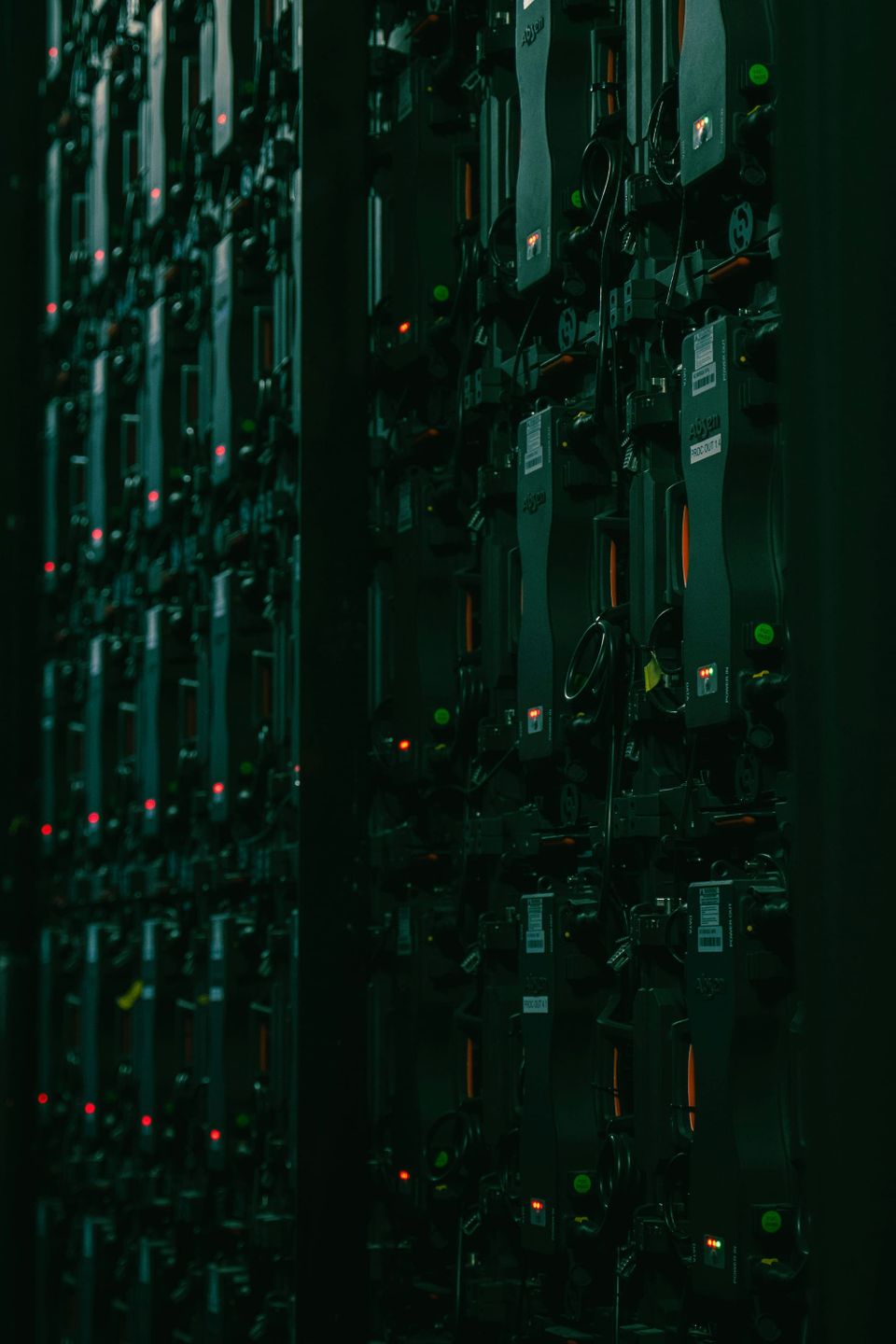 Rows of server racks in a data center - data center electricity forecast