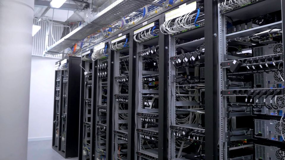 A corridor lined with tall server racks and networking equipment in a data center - Microsoft and Alphabet earnings