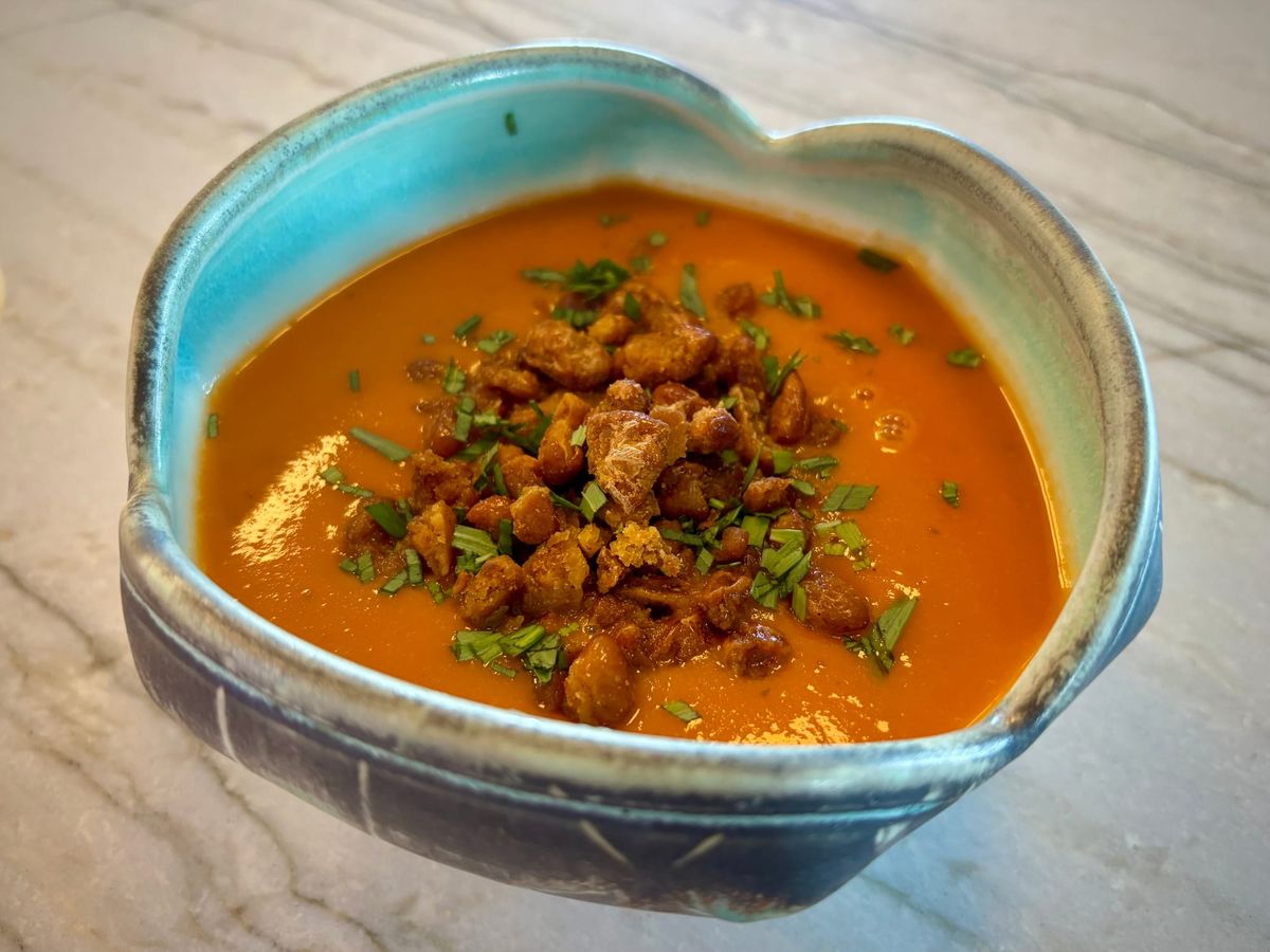 Creamy tomato soup with crispy beans, in a bowl
