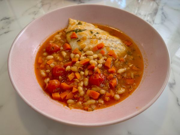 A bowl of fish and bean chowder