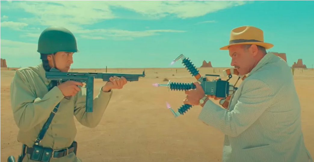 A still from ASTEROID CITY, showing two characters pointing weapons at each other.