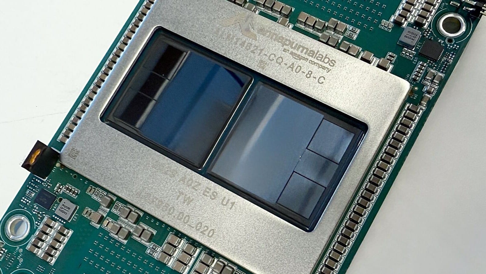 Close-up of an AWS Trainium3 package on a green circuit board