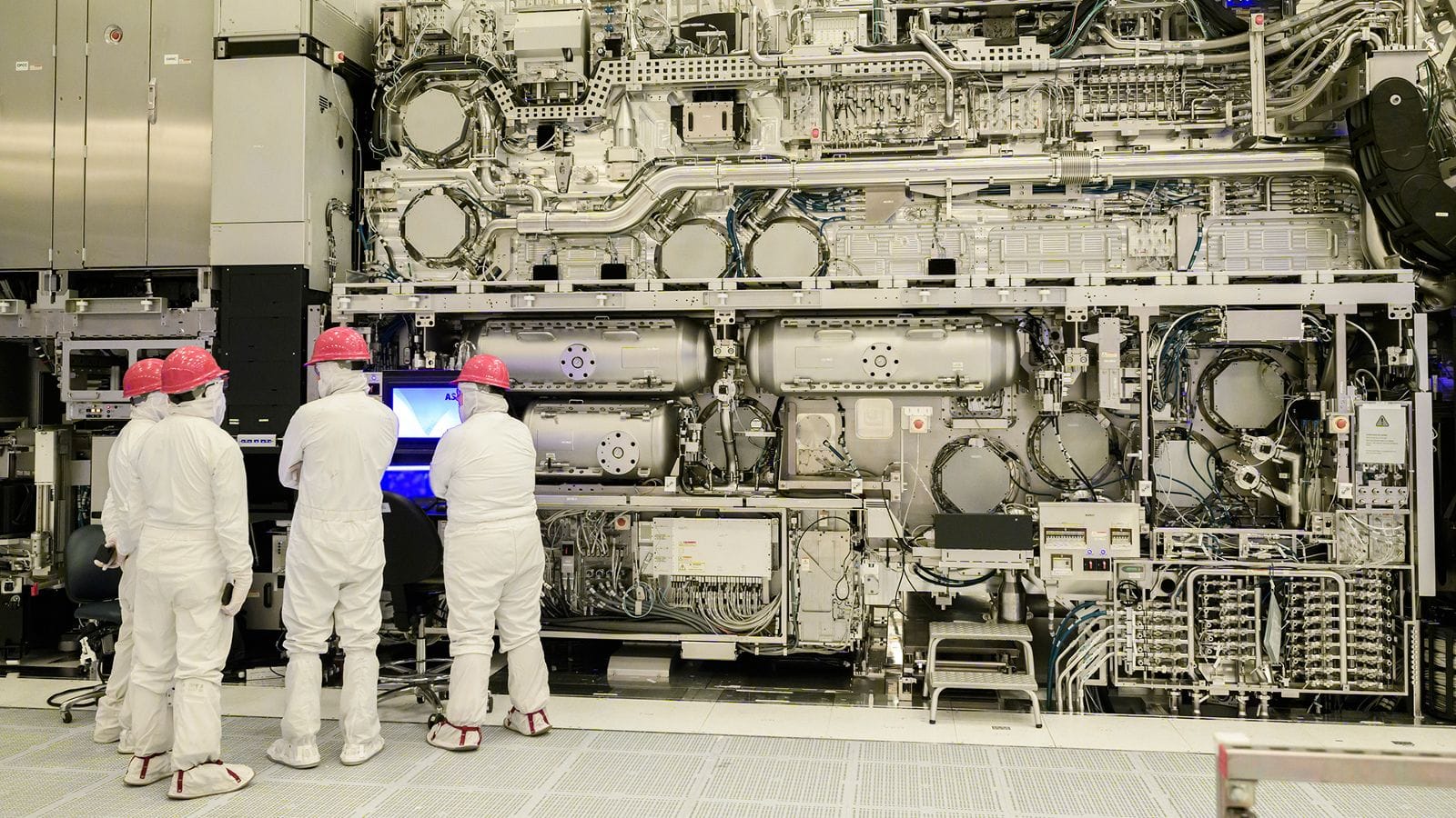 Engineers beside an ASML EXE:5000 High NA EUV lithography tool at Intel Fab 25.