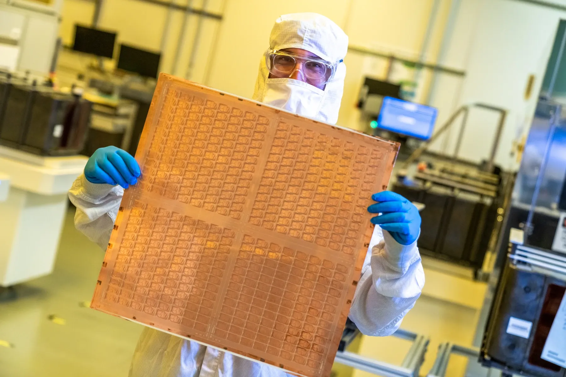 Intel engineer holding a glass-core test panel at Chandler in July 2023
