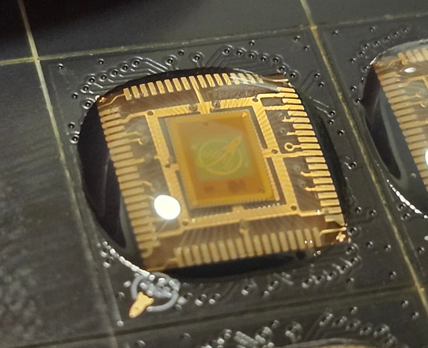 Wafer.space Run 1 chip-on-board part with a visible silicon die and bond wires.