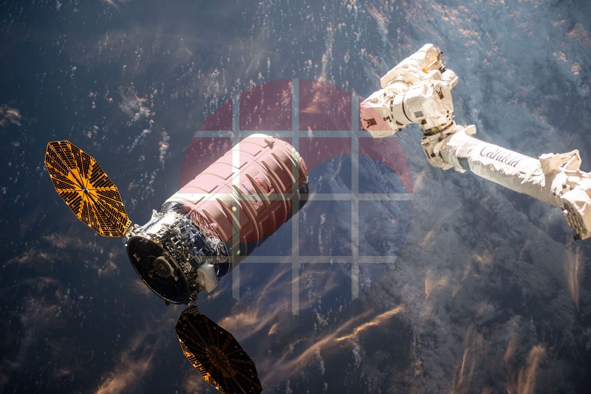 Cygnus OA-6 cargo spacecraft near Canadarm2 above Earth, photographed from the ISS.