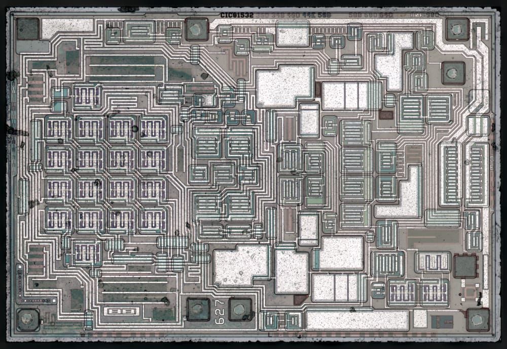 Context image: a historical OPA627 operational-amplifier die photographed by ZeptoBars, not an ADC die.