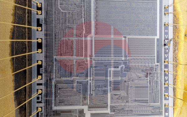 An exposed integrated-circuit die and package bond wires; generic context photograph.