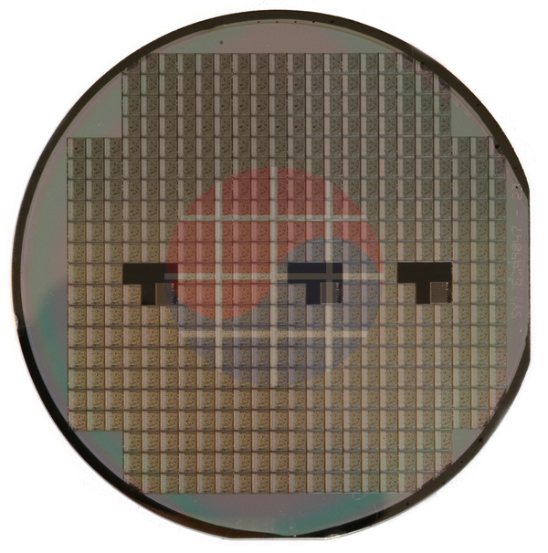 Photograph of a silicon wafer on a white background.