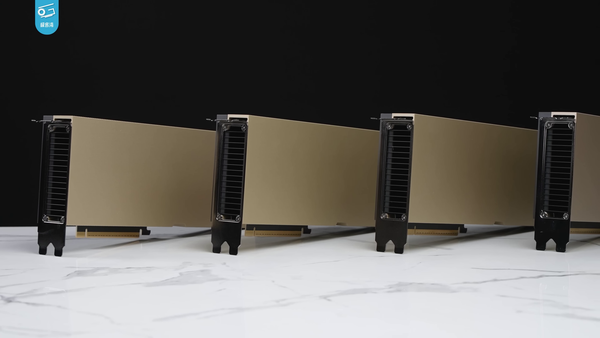 Four NVIDIA H100 PCIe accelerator cards on a tabletop in a Geekerwan video still, photographed on Earth.