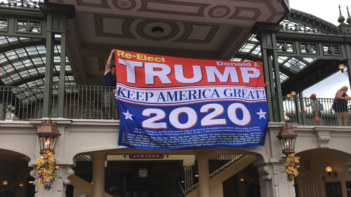 Guest Hangs Trump 2020 Banner on Main Street U.S.A. Train Station