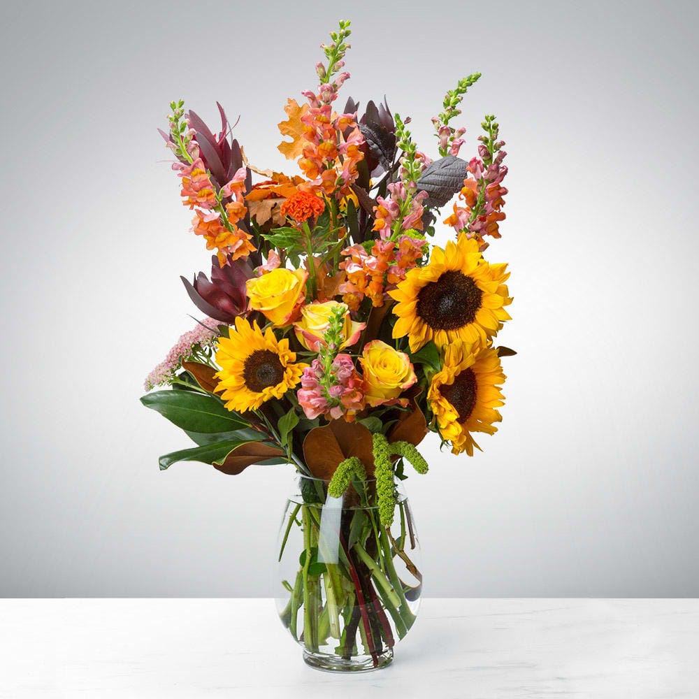 The Harvest Rising autumn floral arrangement from Grace & Blooms in Naples, FL, with sunflowers and roses for a Thanksgiving centerpiece.