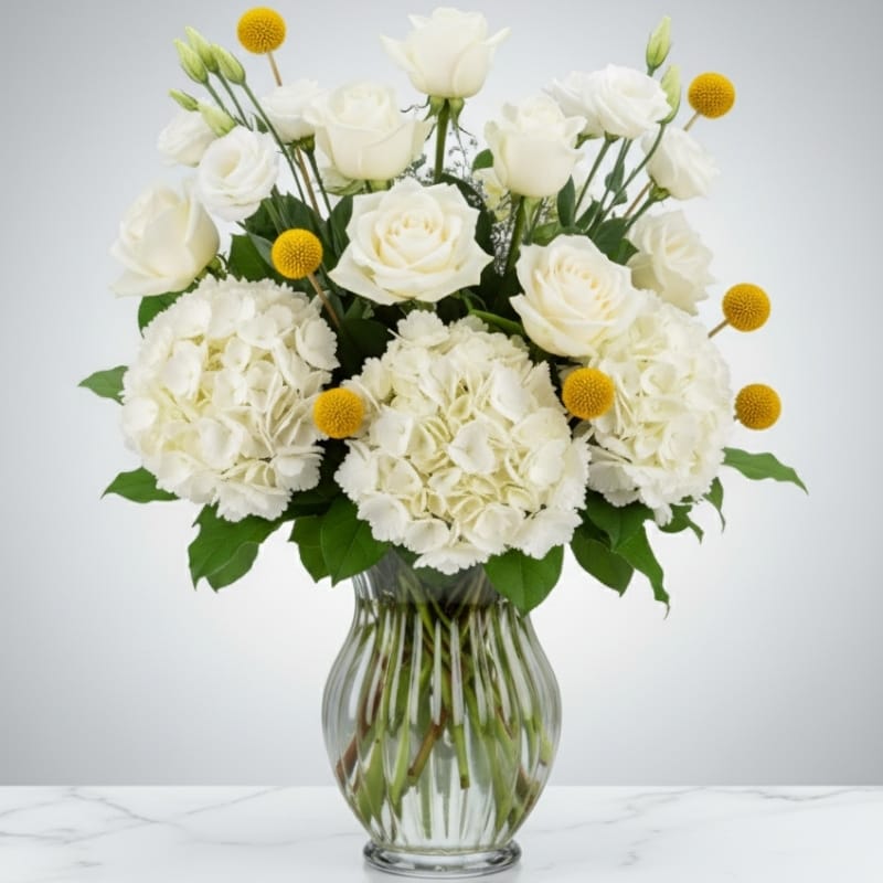 A beautiful Rosh Hashanah centerpiece with white hydrangeas, roses, and pomegranates, created by Grace & Blooms luxury florist in Naples, Florida.