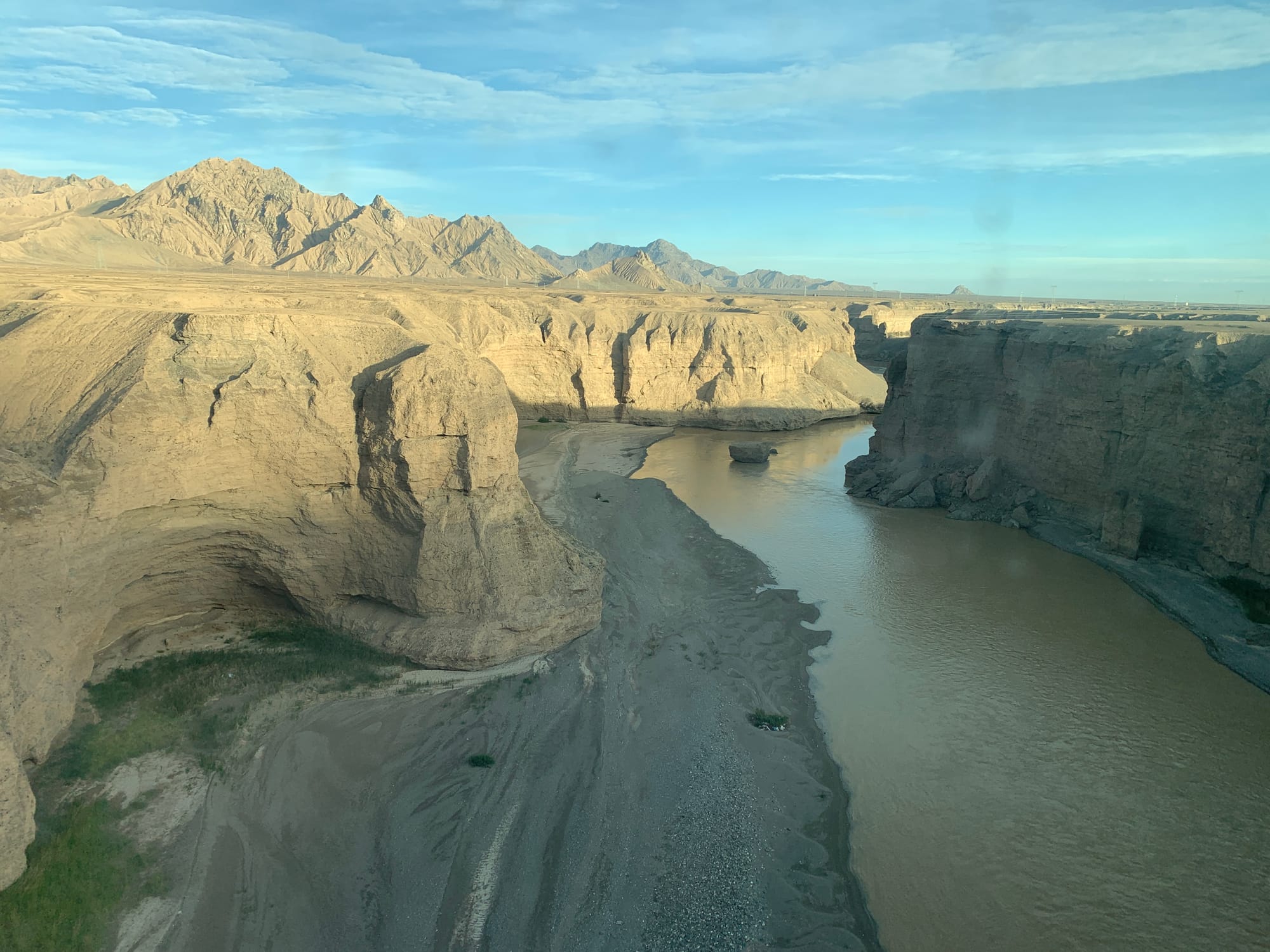 Snow-covered mountains and vast grasslands seen from the Qinghai-Tibet Railway window