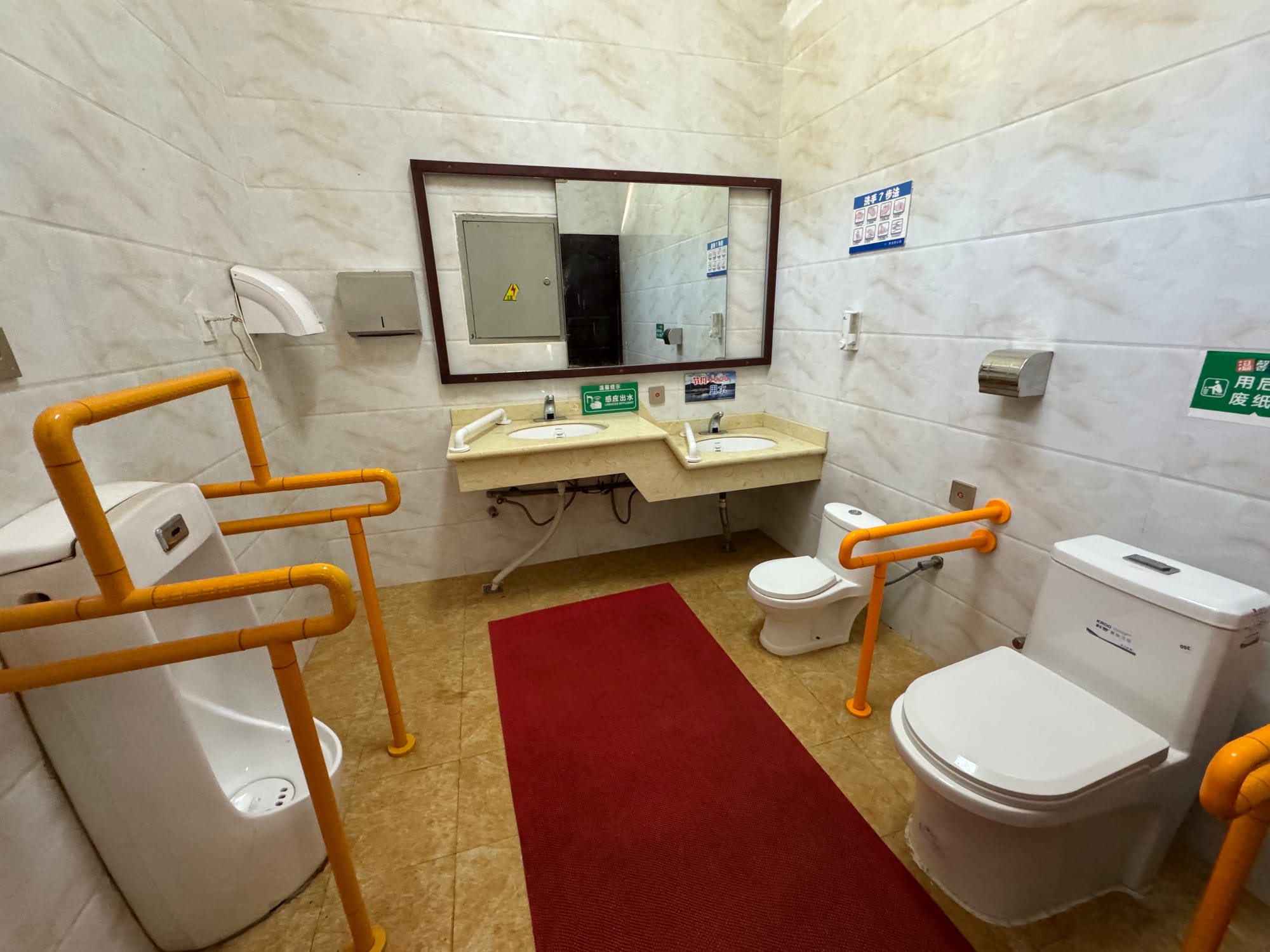 Family restroom with children's toilet and baby-changing station in Lijiang, Yunnan
