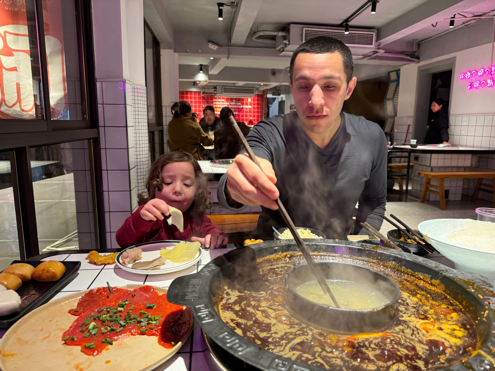 Family selfie after finishing Chongqing hot pot meal with kids