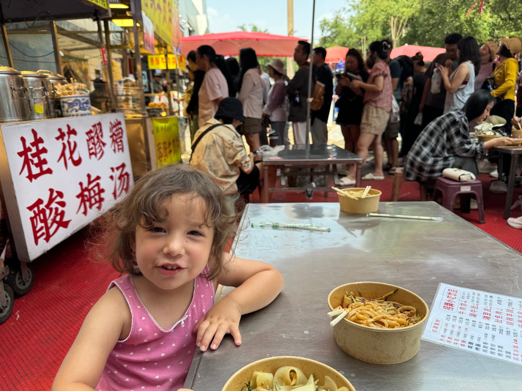 Bustling Muslim Quarter food street with grilled skewers