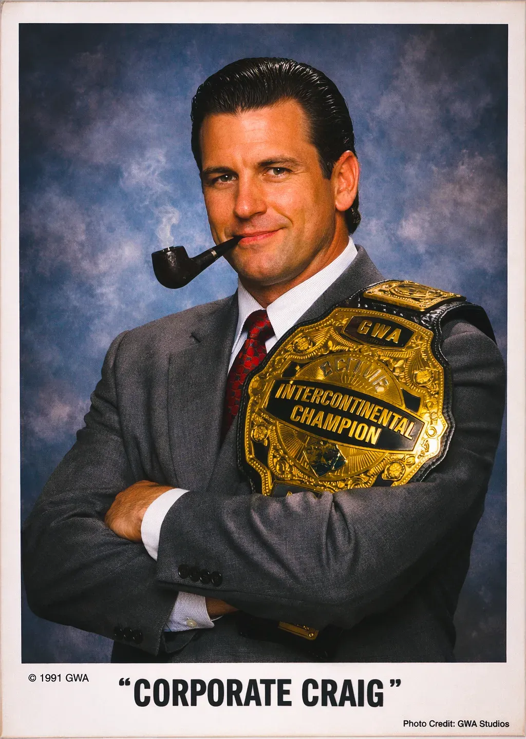 "Corporate" Craig Williams in business suit holding GWA Intercontinental Championship belt with pipe, 1991 studio portrait.