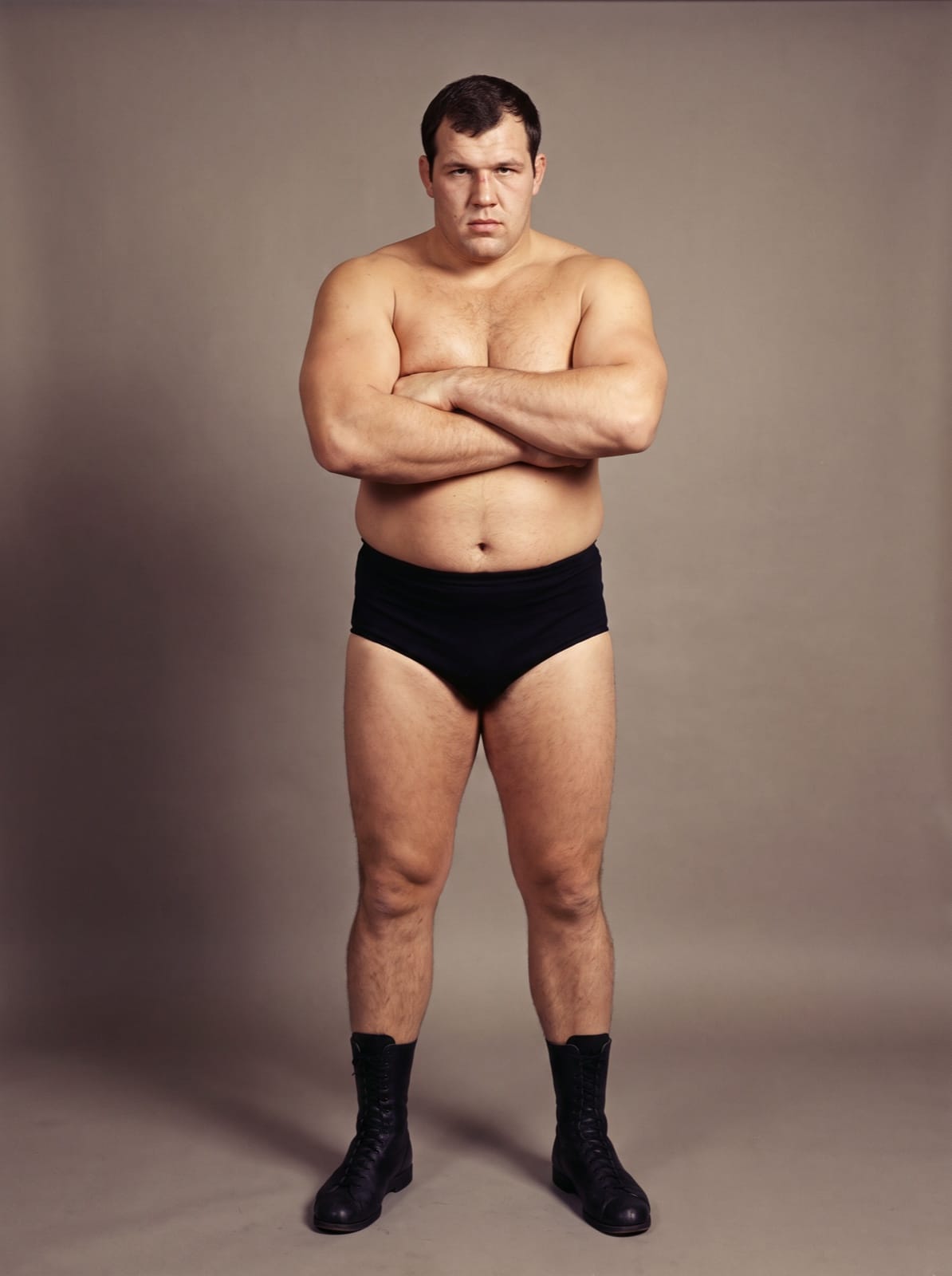 Studio portrait of wrestler Chris Coleman standing with his arms folded