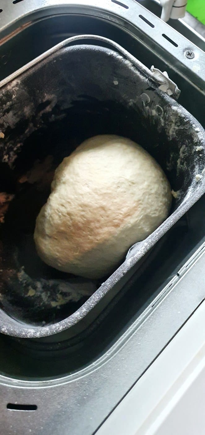 Bollo de masa dentro de la cubeta de la panificadora durante el amasado