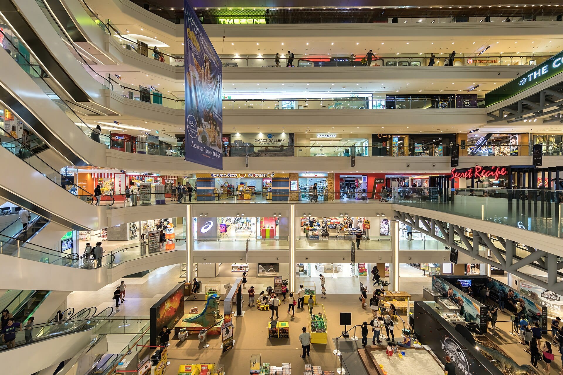 Busy interior of a modern shopping mall with multiple levels of stores