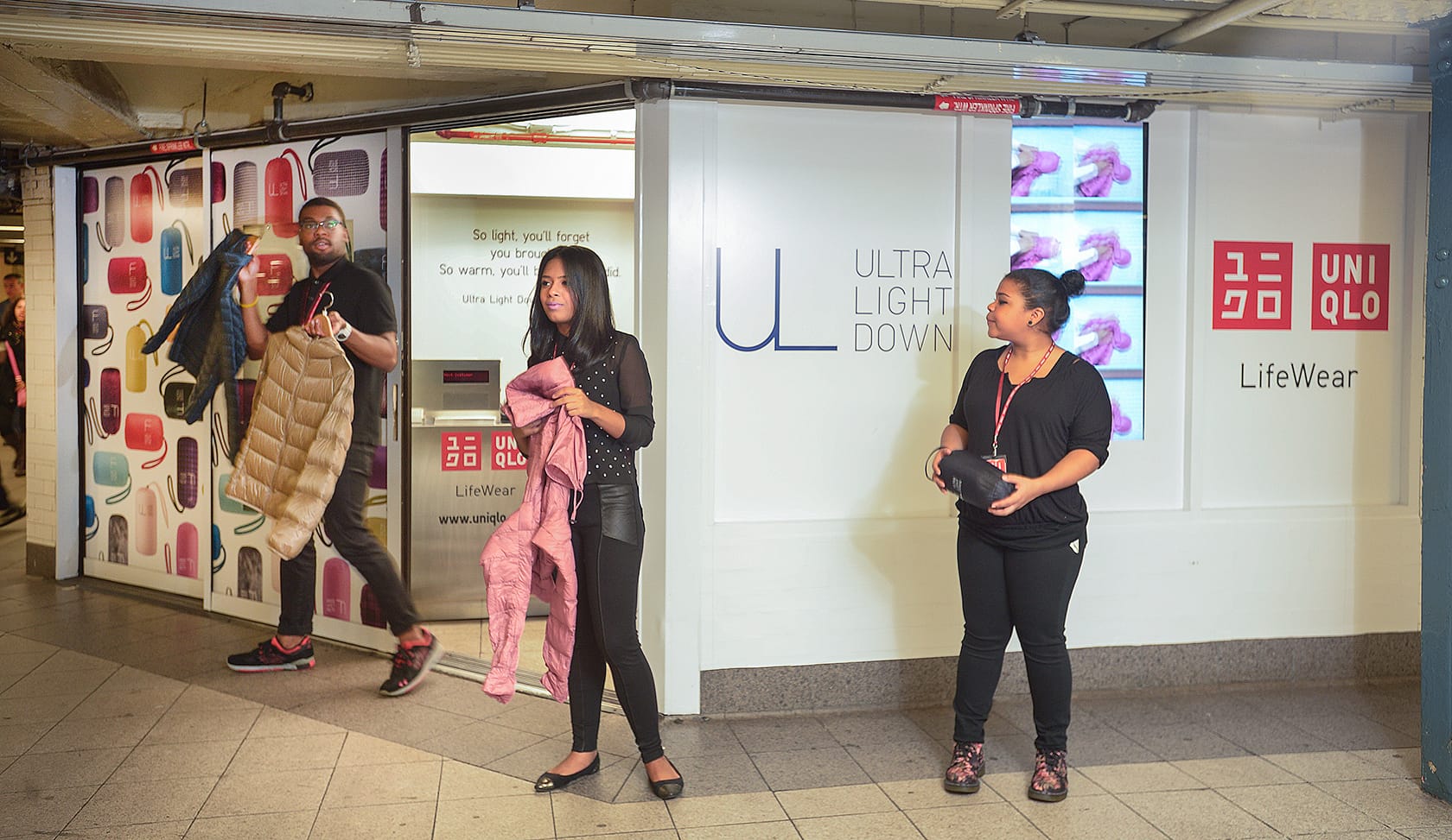 UNIQLO pop-up store entrance in a busy Union Square subway station with people passing by