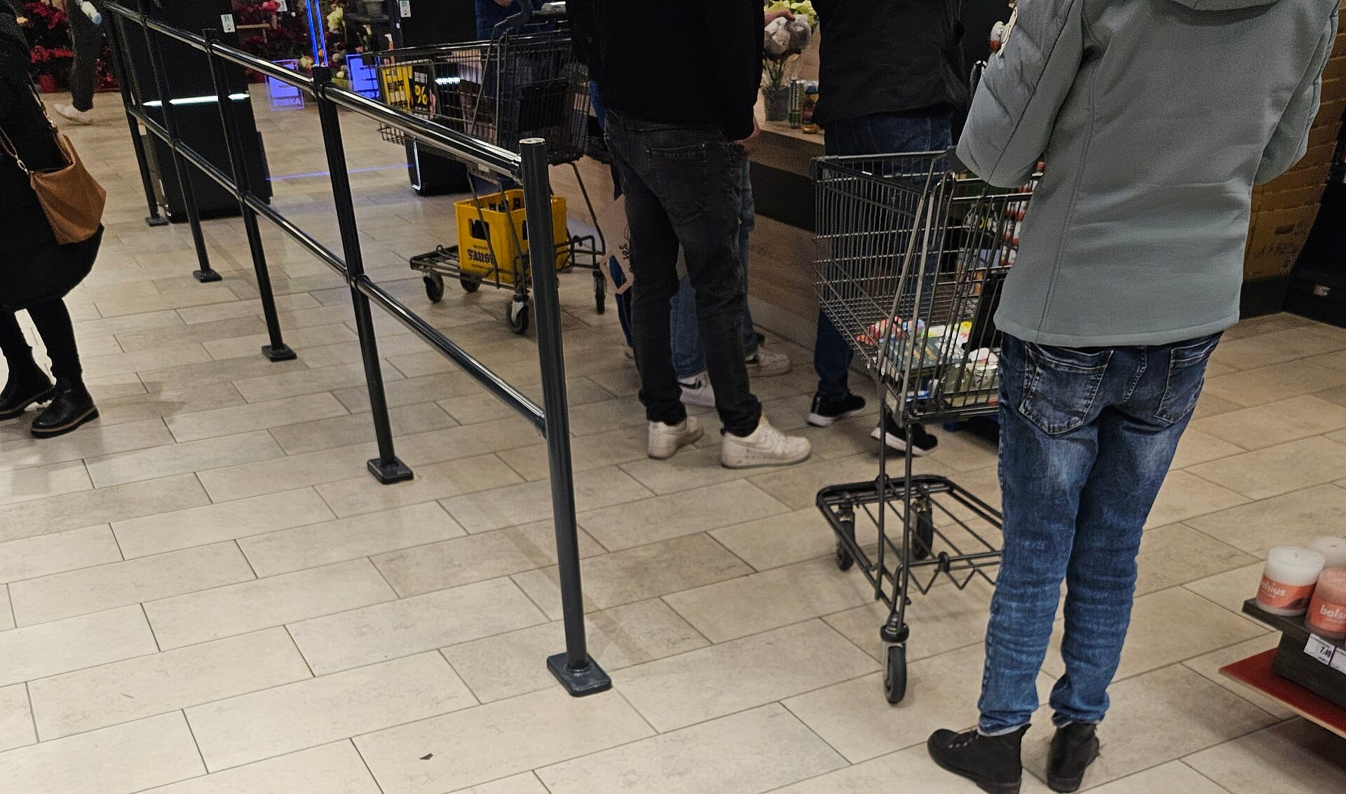 A customer completing a purchase at a supermarket checkout