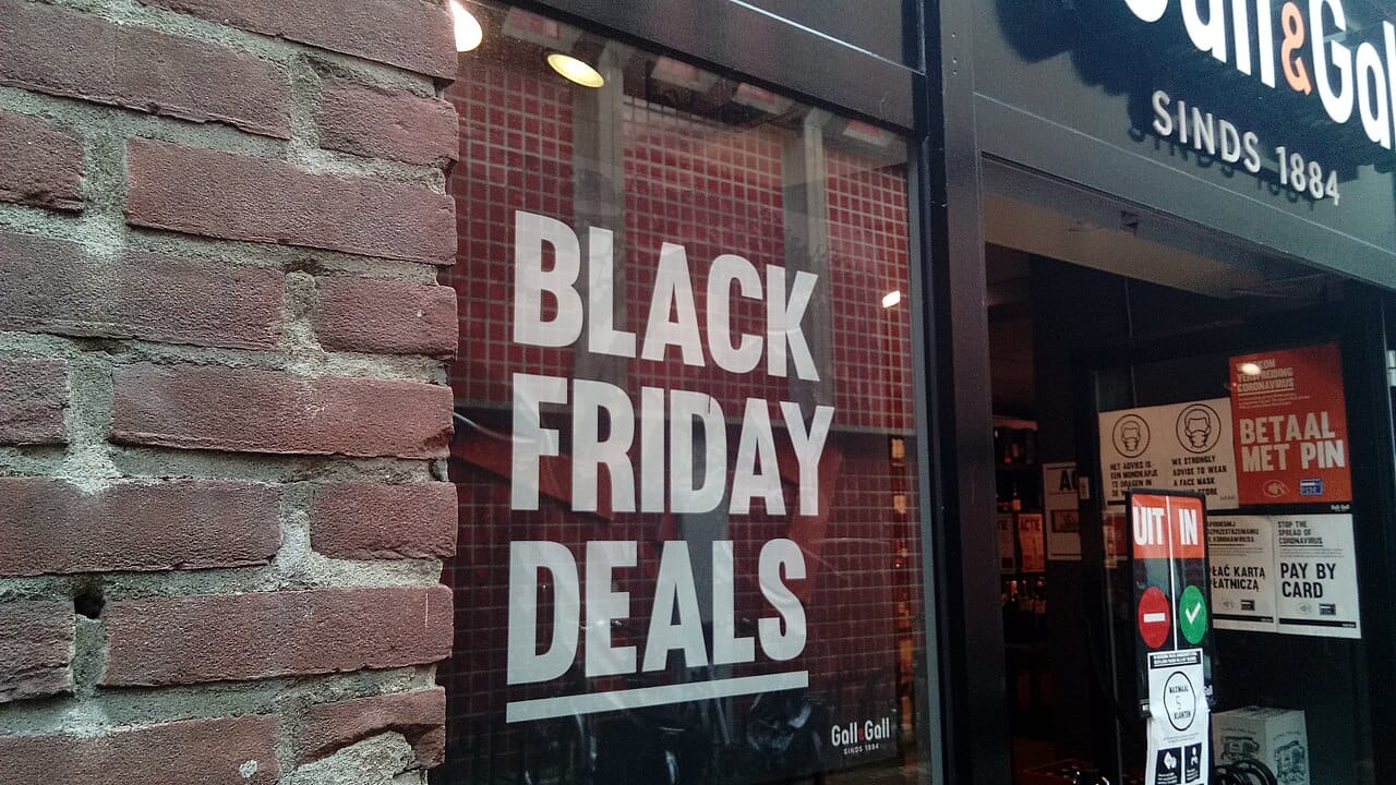 A Black Friday Deals poster displayed in a store window