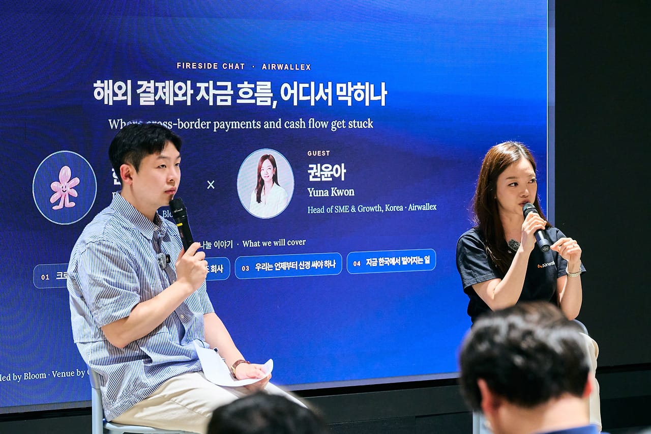 Yuna Kwon and the host with mics, her name and title on the screen behind