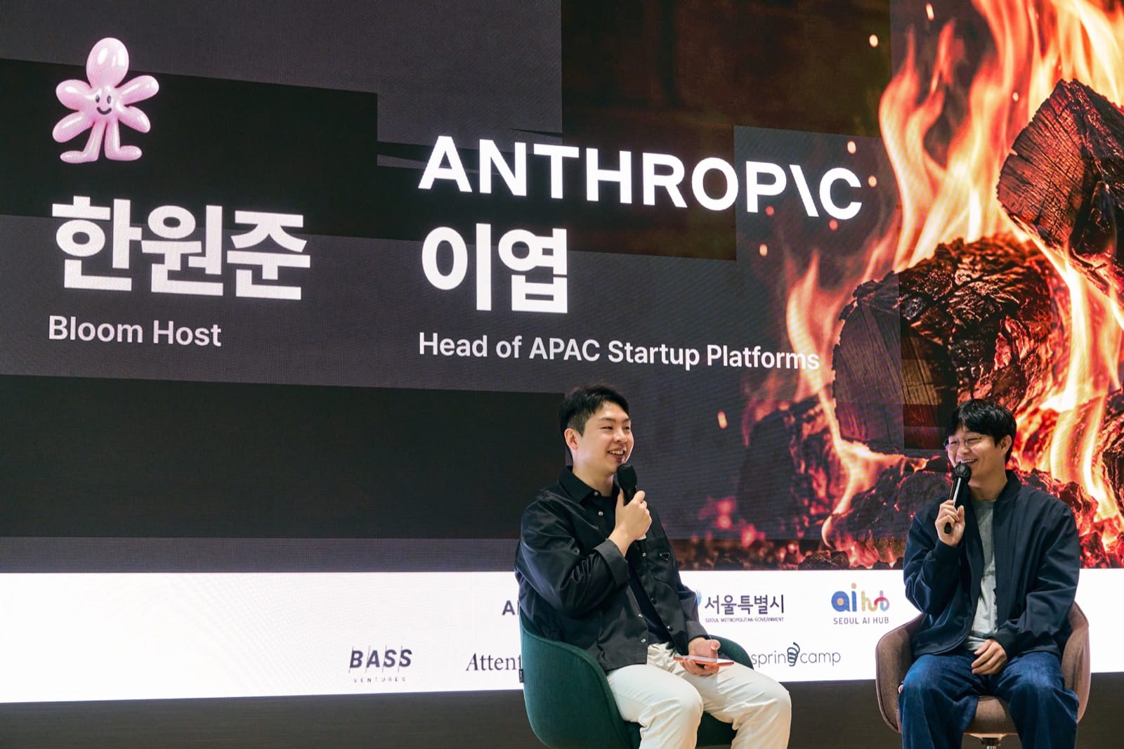 Patrick Han and Anthropic's Yeop Lee in the fireside chat, their names and titles on the LED wall behind them