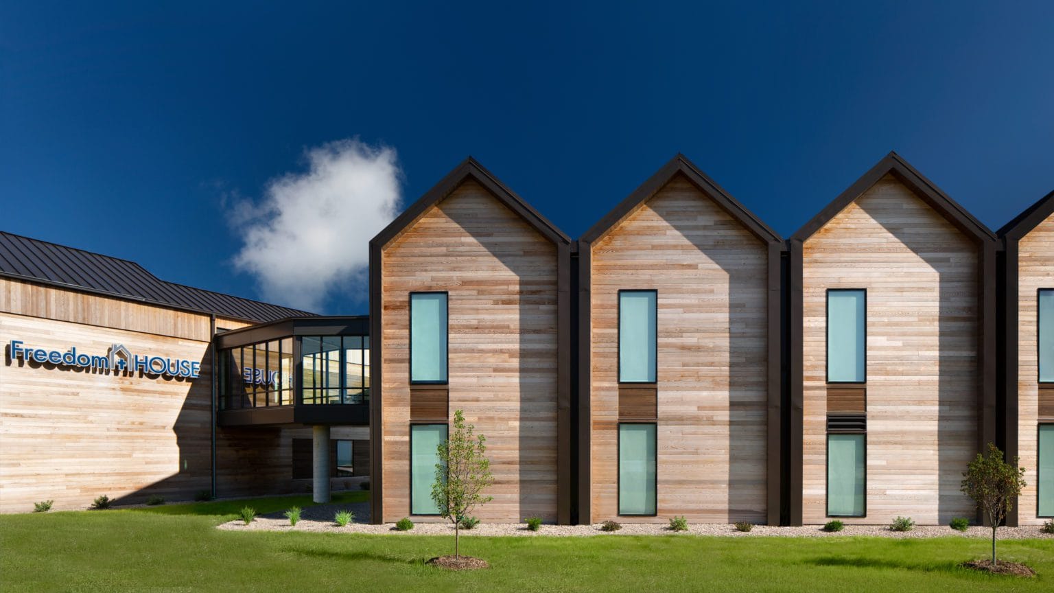 In 2019, Freedom House engaged local architecture firm Berners Schober for a potential remodel of their supportive care facility; the team ultimately pursued a redesign and new construction to replace the previous decaying structure. The resulting building was an award-winning wood-frame housing and administrative facility that tells a story of warmth, simplicity, and integrity.