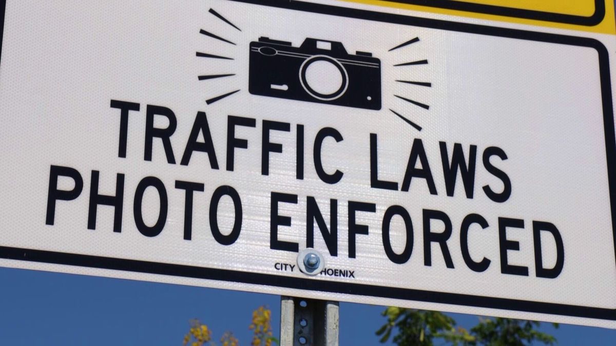photo of "traffic laws photo enforced" street sign