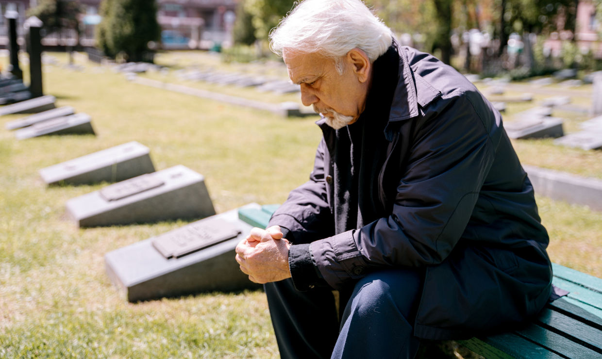 Man grieving at cemetary