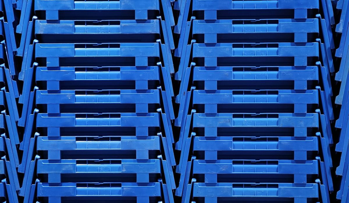 Advanced Micro Devices (AMD) and Meta (META) logos displayed alongside AI data center server racks, reflecting the multiyear AI chip supply agreement.