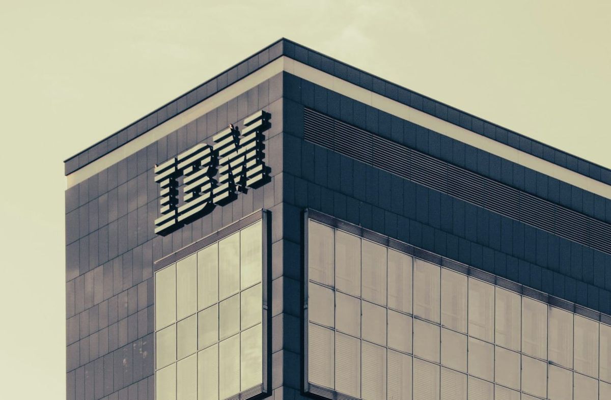IBM logo with cloud and artificial intelligence data visualization representing hybrid cloud and AI strategy